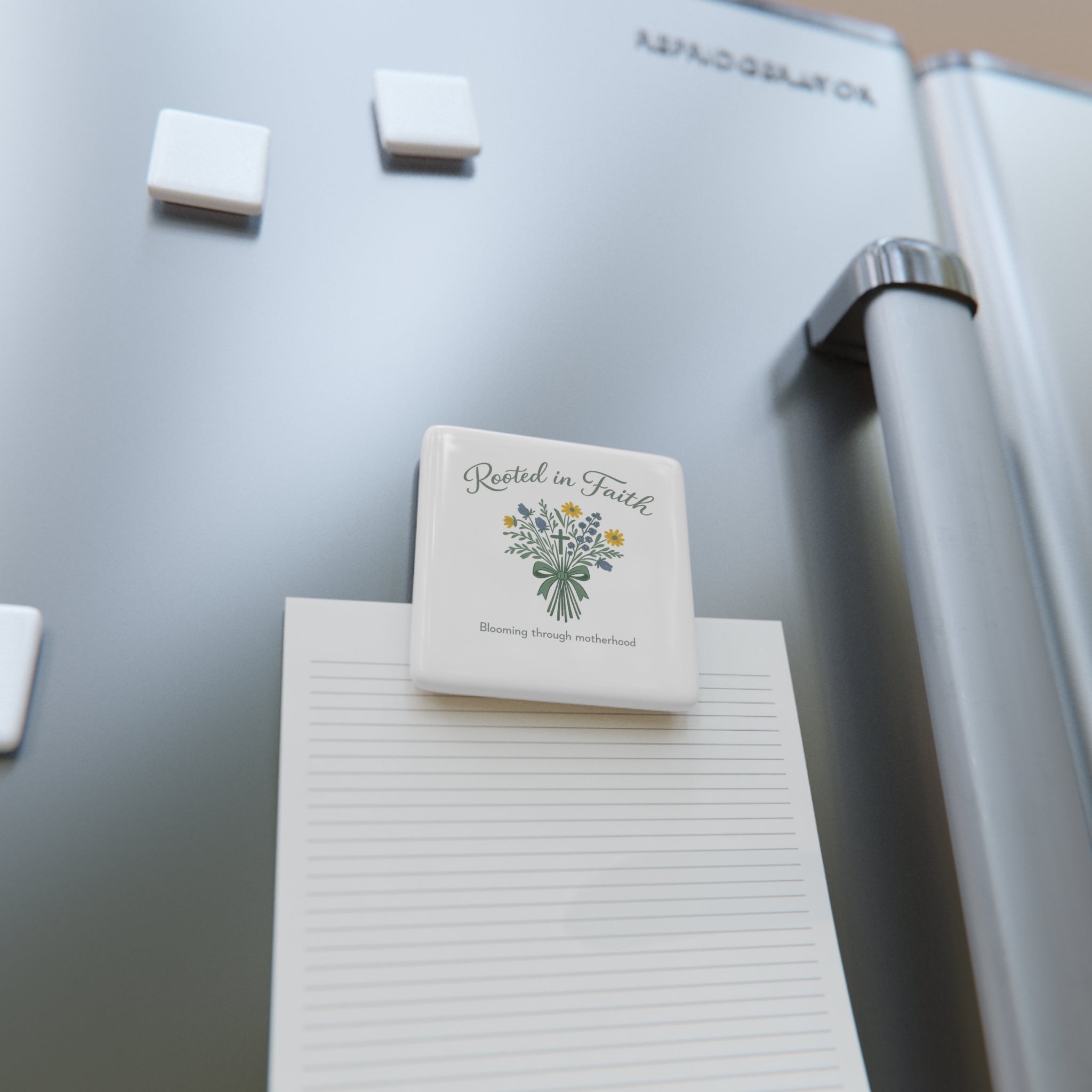 Magnet with 'Rooted in Faith, blooming in motherhood' text on a refrigerator
