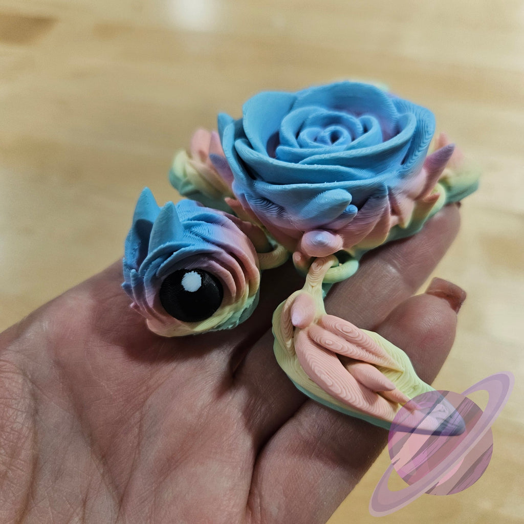 Colorful flower-shaped candies held in a hand on a wooden surface