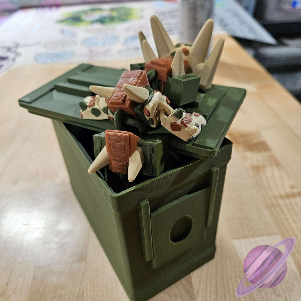 Toy figure of a dinosaur-like creature in a green box on a wooden surface