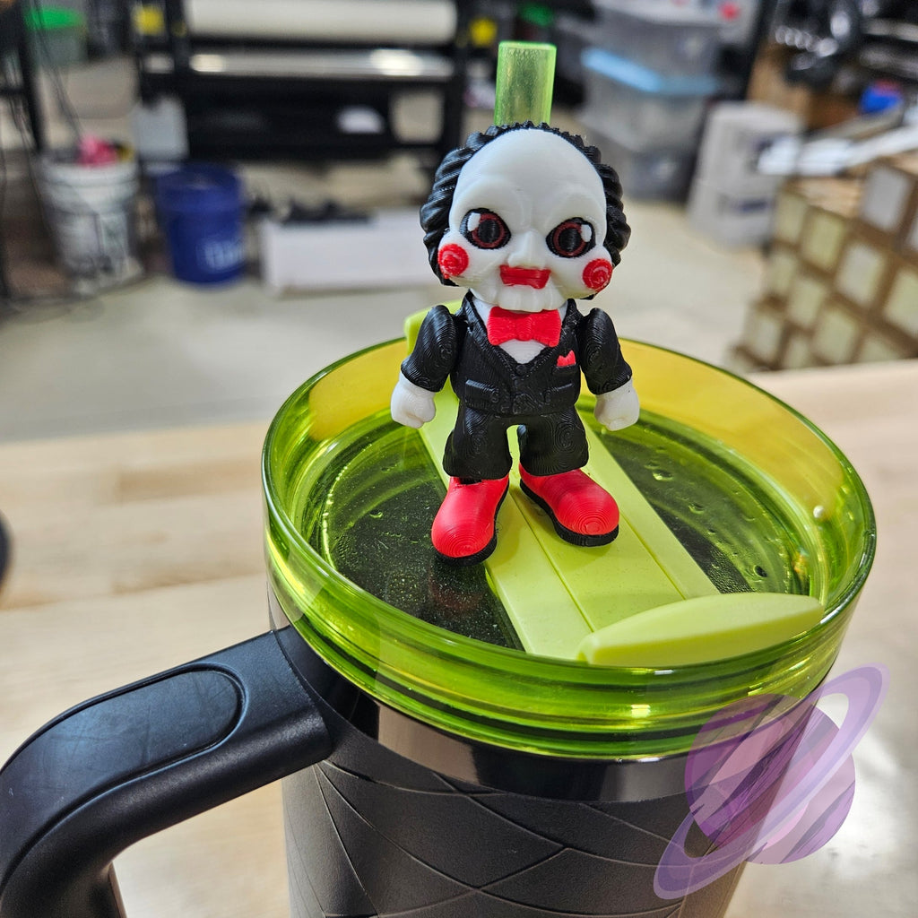 Toy figure on a green lid of a cup with a blurred indoor background