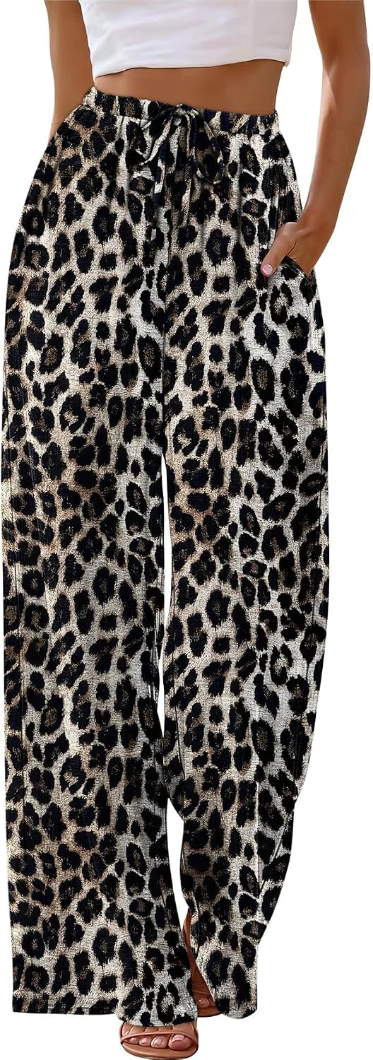 Leopard print pants worn by a person with a white top and sandals.