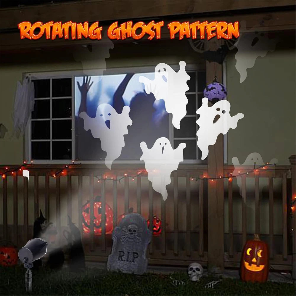 Halloween decorations with ghost patterns projected onto a window, surrounded by pumpkins, tombstones, and lights.