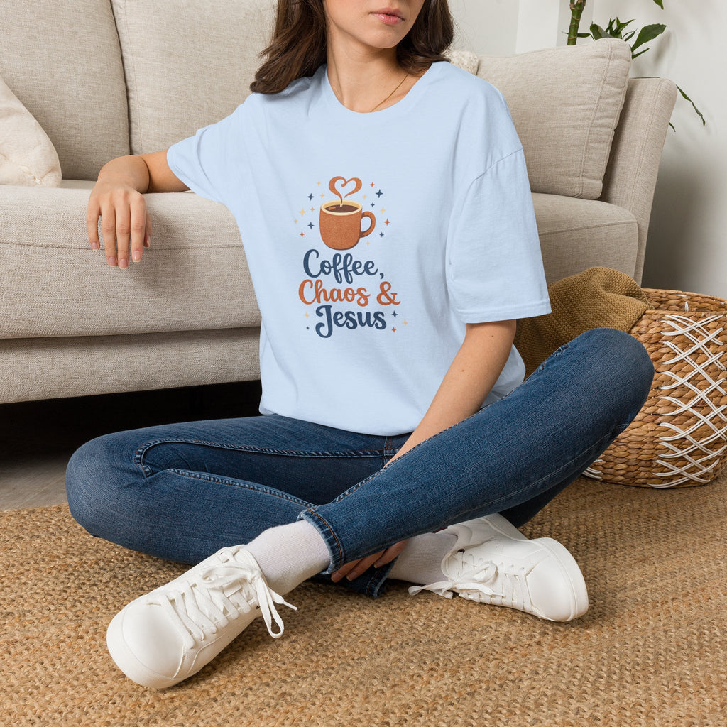 Person wearing a light blue t-shirt with a pizza graphic and text, sitting on a carpeted floor.