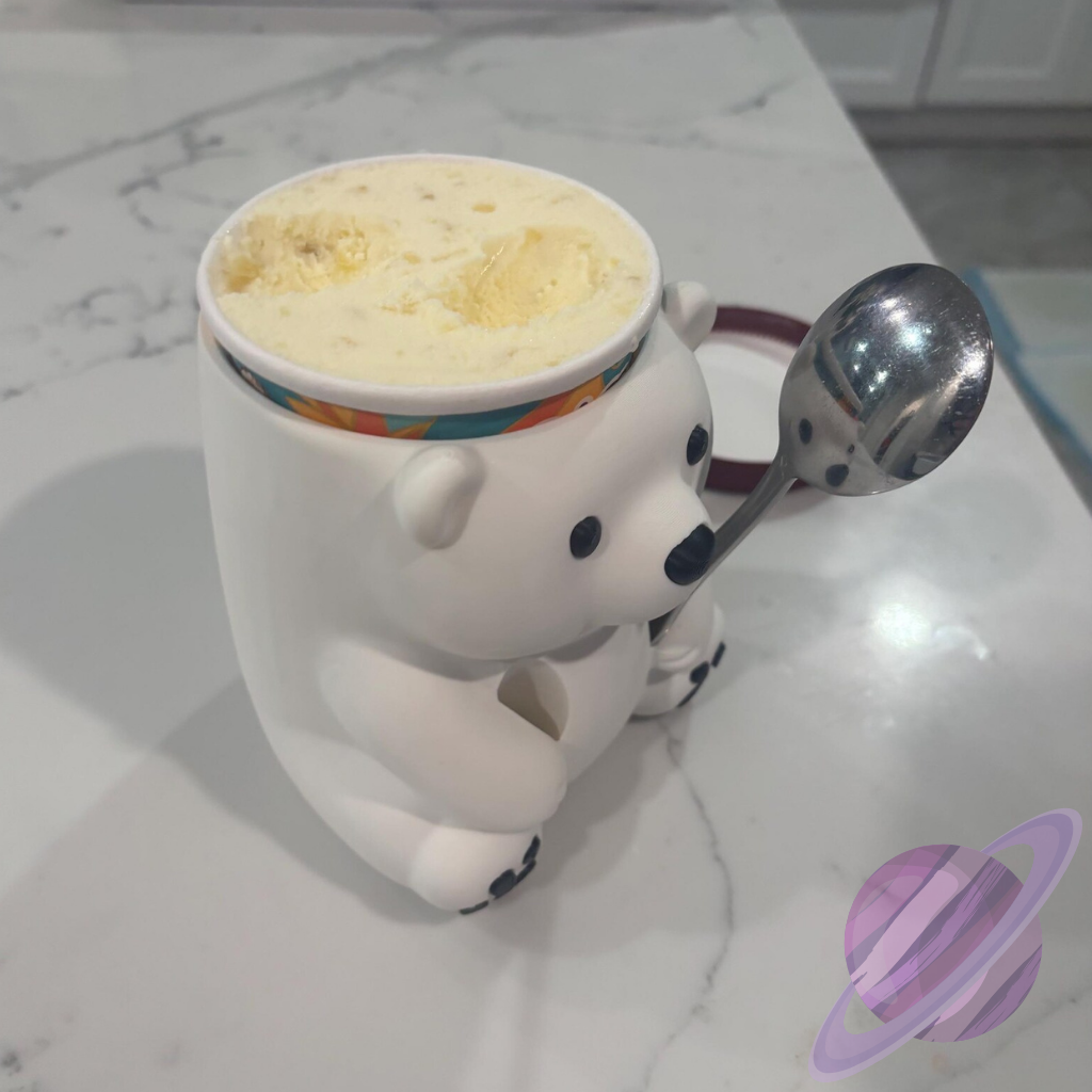 Polar bear mug with a spoon on a marble surface