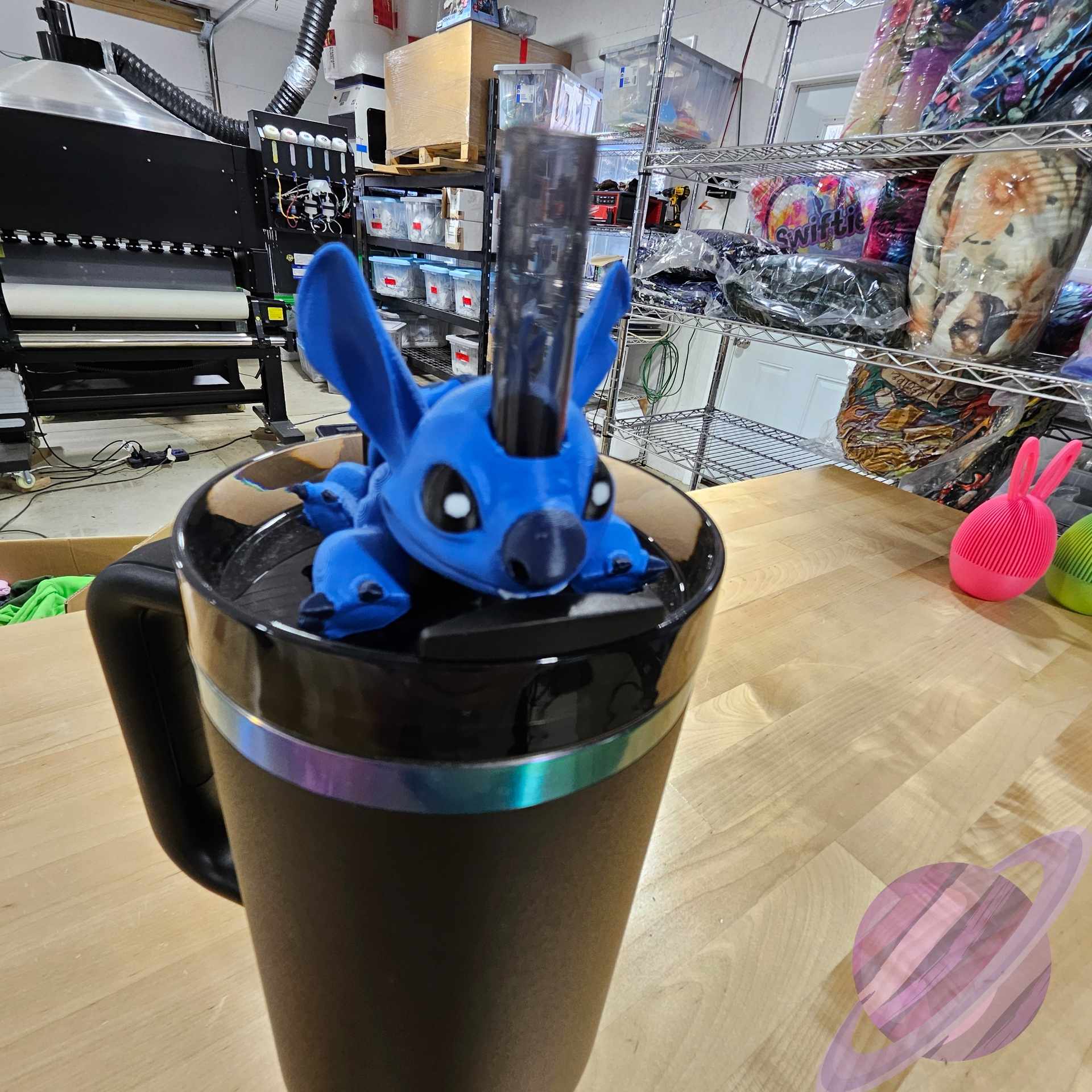 Blue cartoon character on a black mug in a store setting