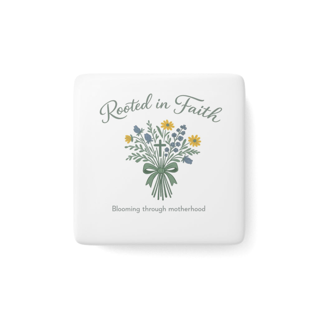 A square white ceramic coaster with rounded corners featuring a floral bouquet illustration and the text 'Rooted in Faith' and 'Blooming through motherhood'.