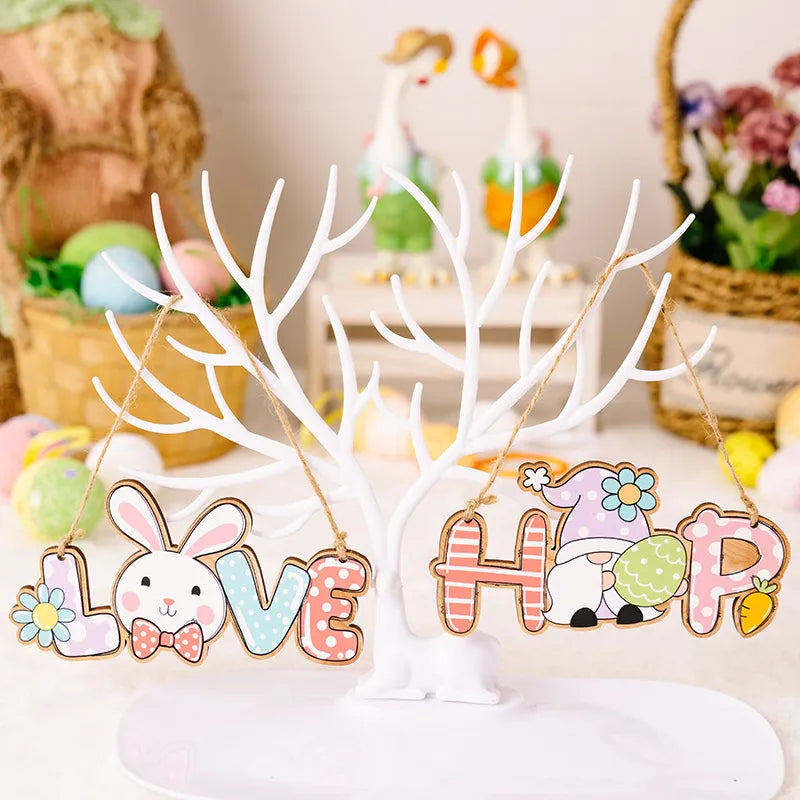 Decorative Easter signs with bunny and gnome designs on a white stand.