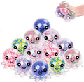 A pile of colorful, octopus-shaped squishy toys with glittery, sparkly eyes and small tentacles, alongside a hand holding one of the larger toys in the top right corner.