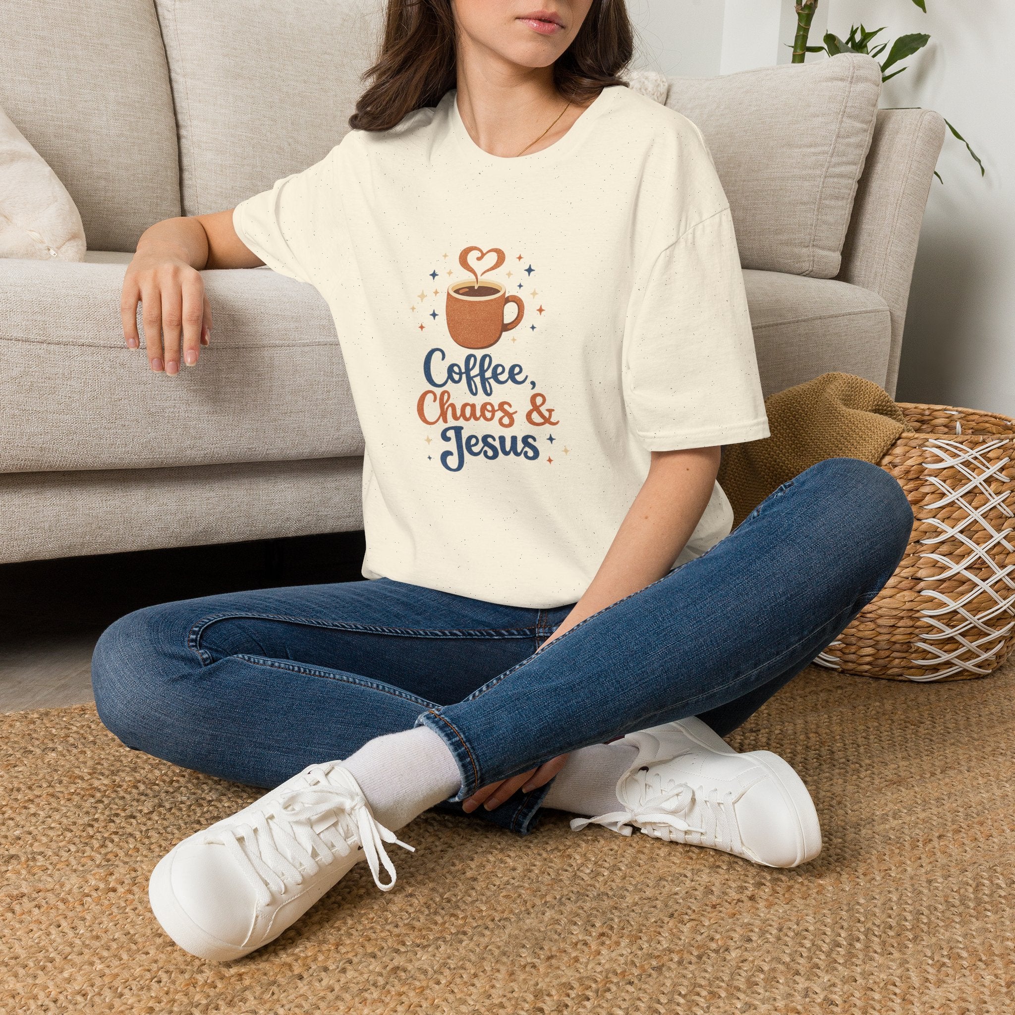 Person wearing a 'Happy Camper' t-shirt sitting on the floor in a living room.