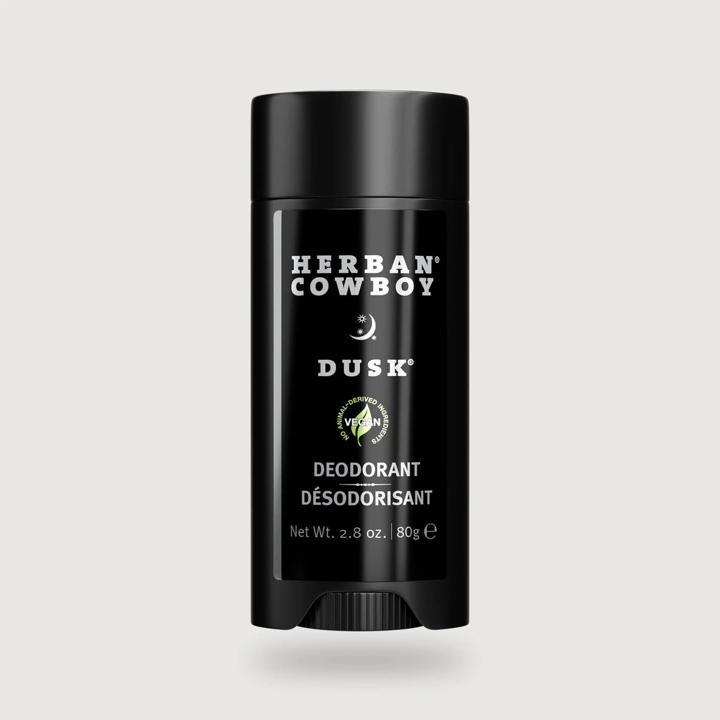 Herban Cowboy Dusk deodorant stick on a light gray background