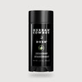 Herban Cowboy Dusk deodorant stick on a light gray background