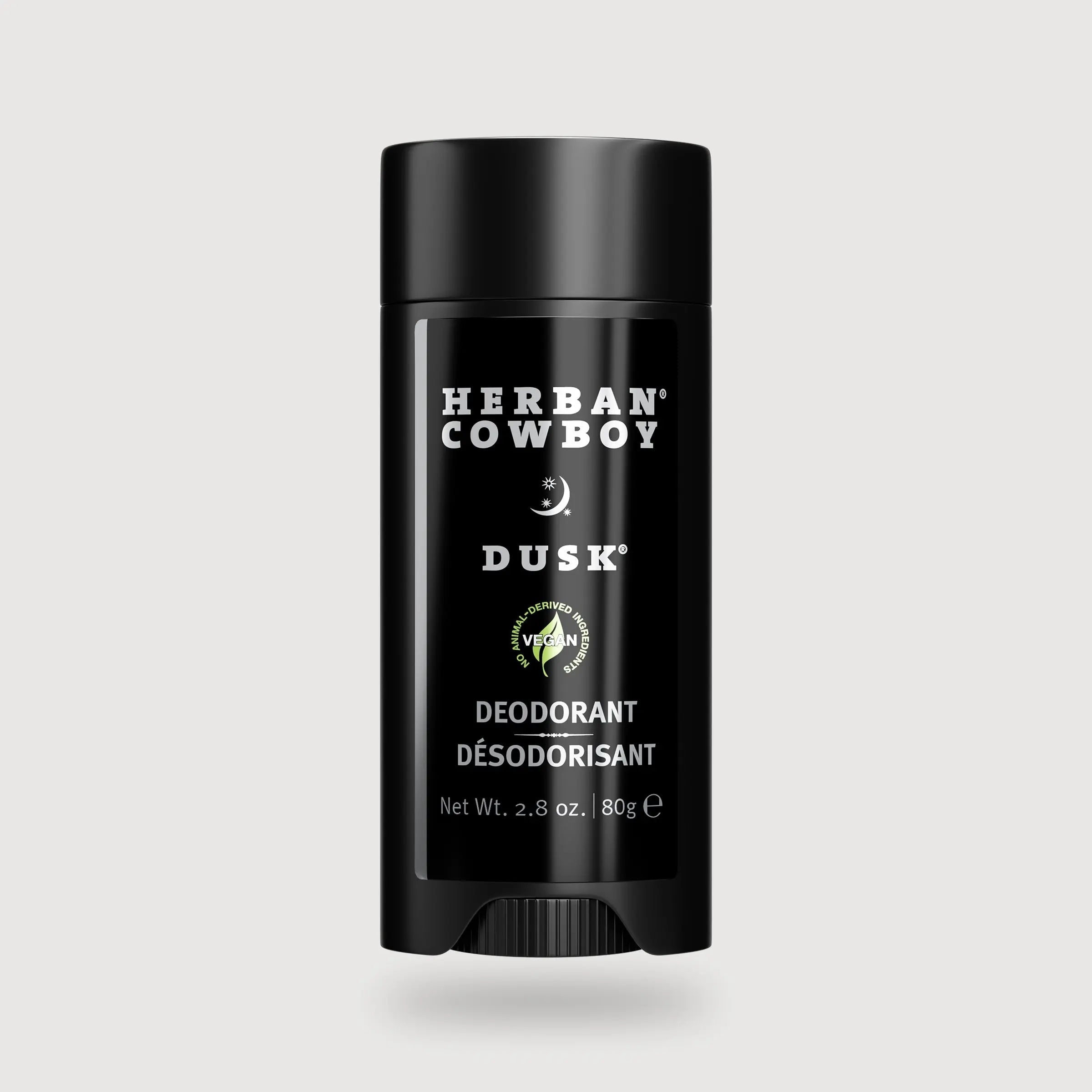 Herban Cowboy Dusk deodorant stick on a light gray background