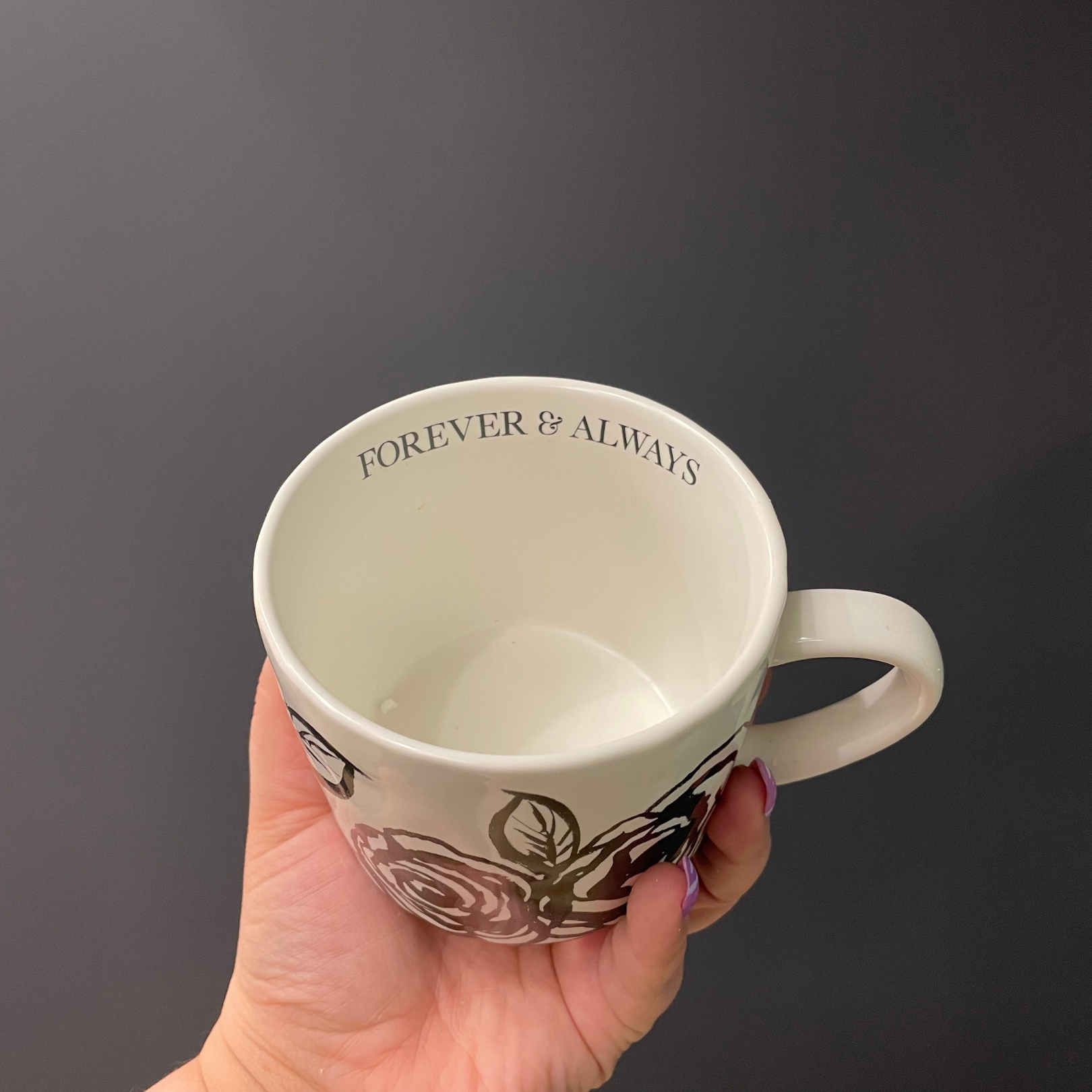 White mug with 'Forever & Always' text held against a dark background