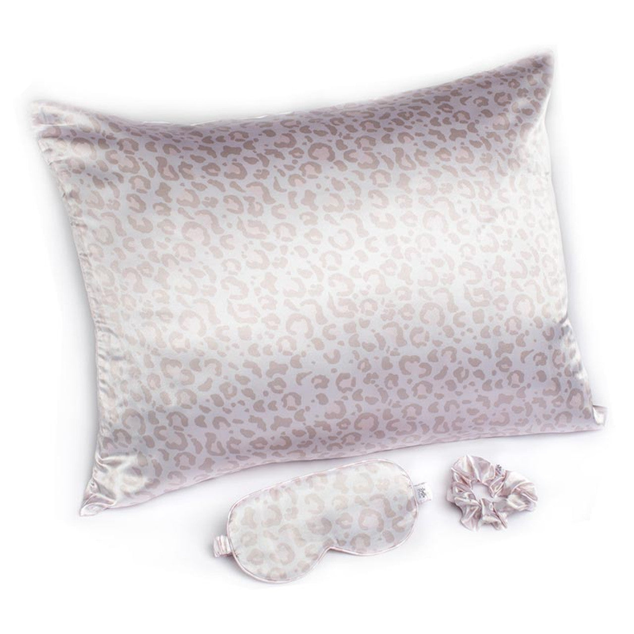 Silk pillowcase, eye mask, and earplugs with leopard print pattern on a white background