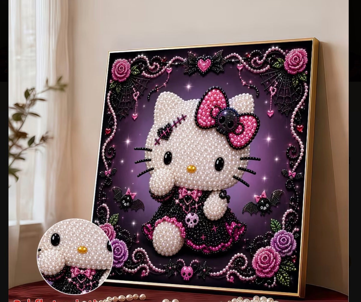 A framed decorative artwork featuring a stylized Hello Kitty character made from white pearl-like beads, with a pink bow, black dress details, and a dark purple gothic background with roses, bats, and decorative swirls. The frame is gold-toned and the piece is photographed leaning indoors against a light wall.