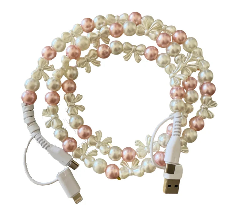 Decorative USB cable with pearl-like beads on a white background