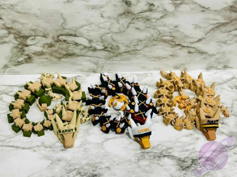 Three toy figures resembling military vehicles on a marble surface