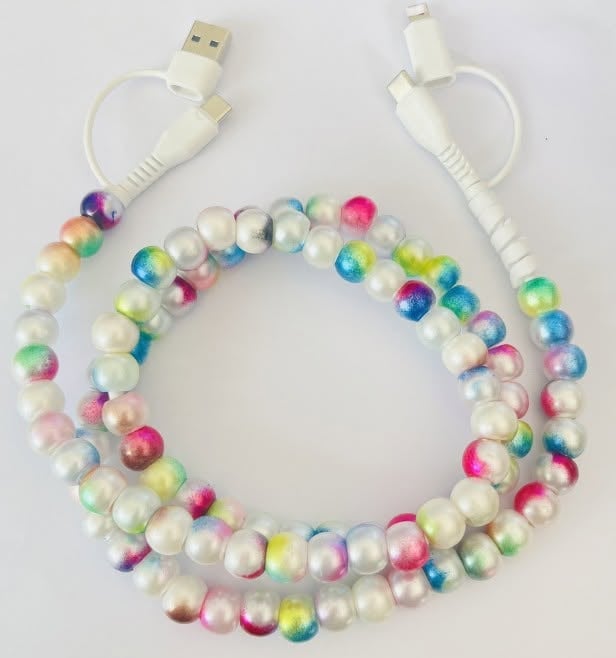 A multi color pearl-bead phone cable coiled in a circle, with white USB-A to USB-C and USB-A to Lightning connectors on a plain white background.
