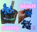 Blue alien straw buddy toy with packaging and close-up on a light blue background