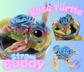 Colorful turtle straw buddy with rose design on a light blue background
